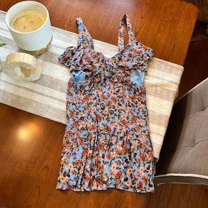 Beautiful floral dress.  Open on the sides and open in the back.